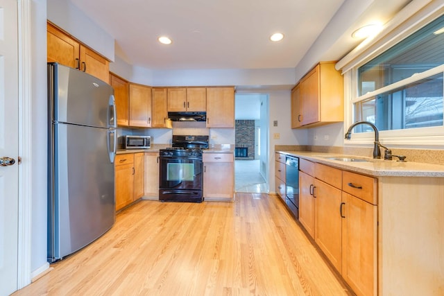 26 Prairie Dr, Westmont, IL 60559 - kitchen with recessed lighting, under cabinet range hood, a sink, light wood-style floors, and appliances with stainless steel finishes