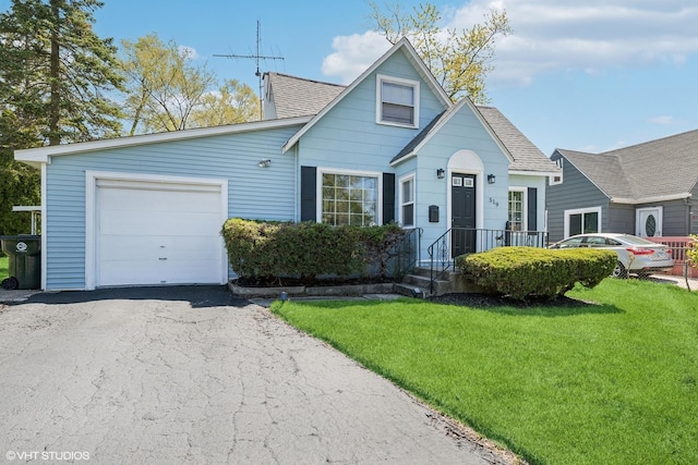519 Catalpa Dr, Round Lake, IL 60073 - view of front of house featuring roof with shingles, a front yard, an attached garage, and asphalt driveway
