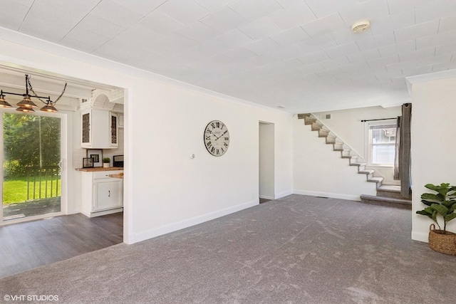 519 Catalpa Dr, Round Lake, IL 60073 - unfurnished living room with carpet floors, stairway, baseboards, and ornamental molding