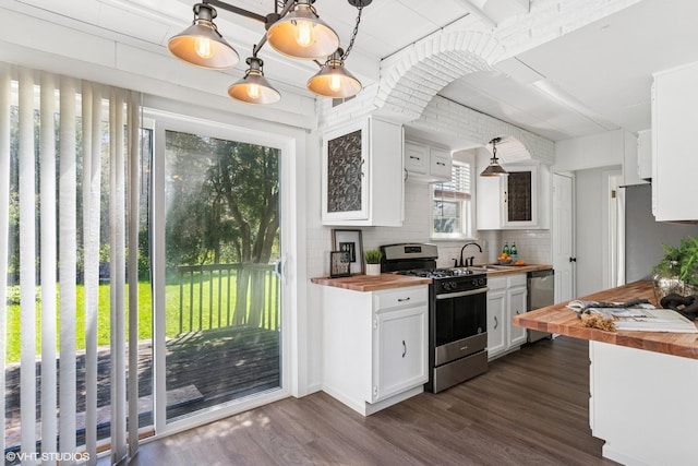 519 Catalpa Dr, Round Lake, IL 60073 - kitchen featuring appliances with stainless steel finishes, butcher block countertops, tasteful backsplash, white cabinetry, and dark wood-type flooring
