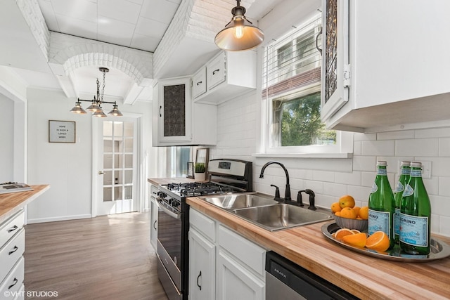 519 Catalpa Dr, Round Lake, IL 60073 - kitchen with stainless steel appliances, a sink, wooden counters, wood finished floors, and white cabinets
