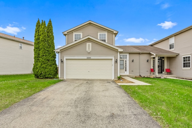 view of front of property featuring asphalt driveway, a front yard, and an attached garage