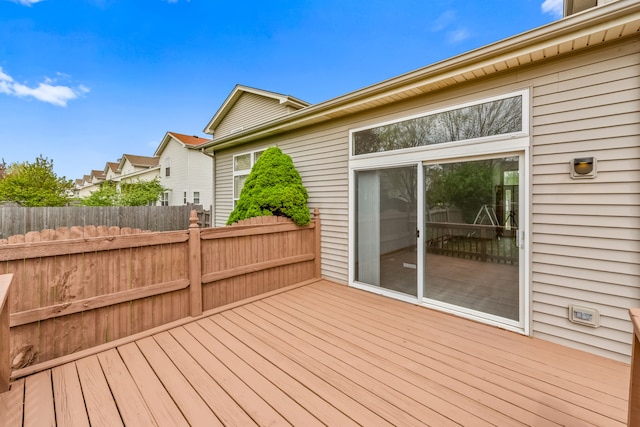 wooden terrace featuring fence