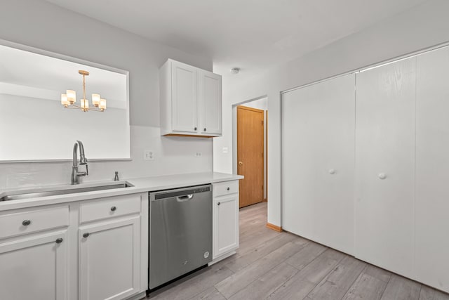kitchen with dishwasher, a sink, a chandelier, light wood-style floors, and light countertops
