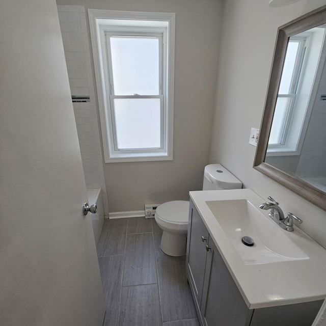 5321 W Crystal St, Chicago, IL 60651 - bathroom featuring toilet, baseboards, vanity, and wood finished floors