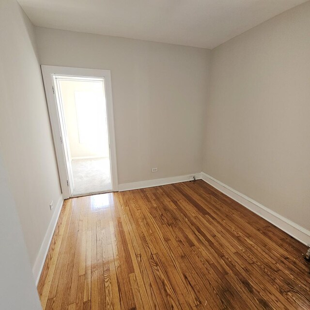 5321 W Crystal St, Chicago, IL 60651 - empty room with baseboards and hardwood / wood-style floors