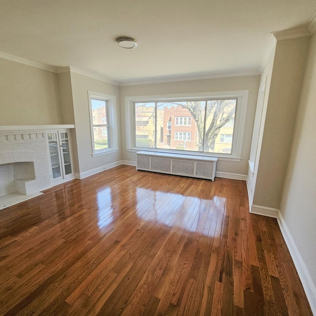 5321 W Crystal St, Chicago, IL 60651 - unfurnished living room featuring baseboards, radiator, ornamental molding, and hardwood / wood-style flooring