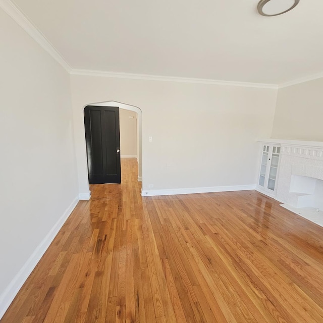 5321 W Crystal St, Chicago, IL 60651 - unfurnished living room with baseboards, ornamental molding, and light wood-style flooring