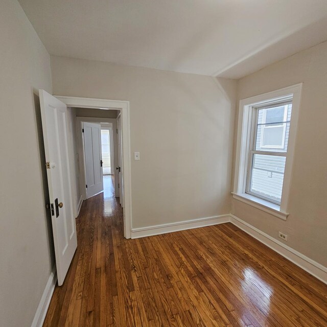 5321 W Crystal St, Chicago, IL 60651 - empty room with baseboards and dark wood-style floors