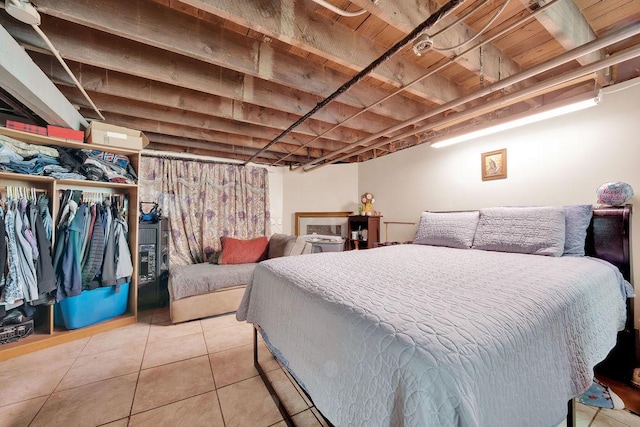 bedroom with a closet and light tile patterned flooring