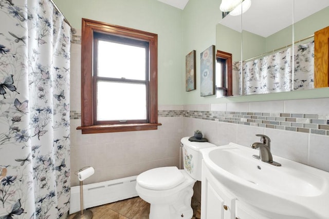 bathroom with toilet, tile walls, baseboard heating, and a wealth of natural light