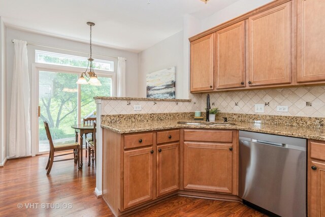 kitchen featuring dishwasher, a sink, tasteful backsplash, and dark wood finished floors