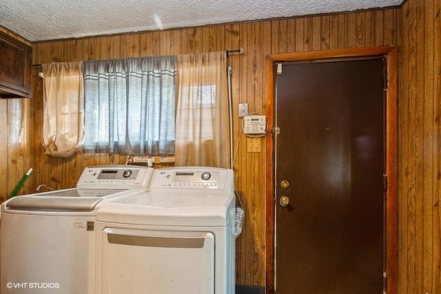 15427 Winchester Ave, Harvey, IL 60426 - clothes washing area with wood walls, laundry area, a textured ceiling, a healthy amount of sunlight, and separate washer and dryer