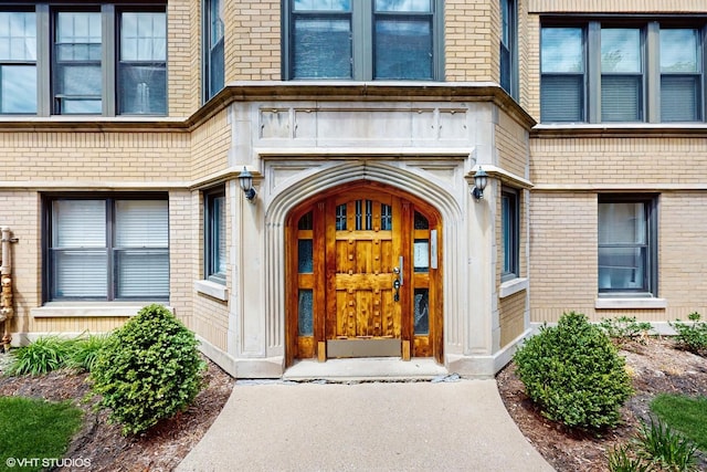property entrance featuring brick siding