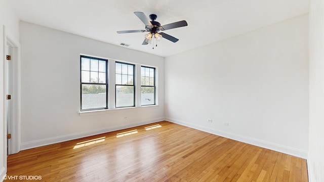unfurnished room featuring light wood-style floors, ceiling fan, and baseboards