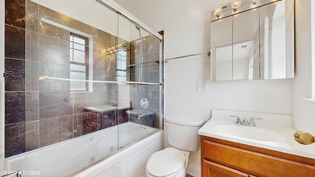 bathroom featuring vanity, toilet, and enclosed tub / shower combo