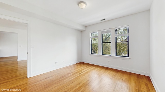 unfurnished room featuring light wood finished floors and baseboards