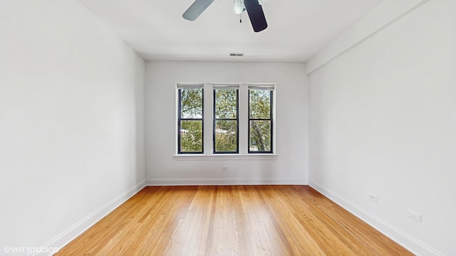 unfurnished room with light wood-style flooring, baseboards, and a ceiling fan