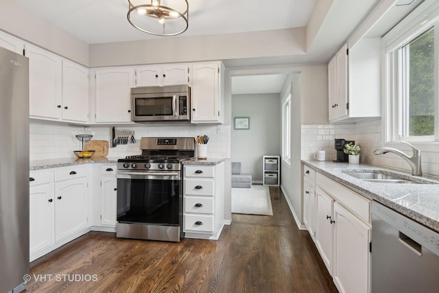 690 Queenswood Ln, Wheaton, IL 60189 - kitchen with stainless steel appliances, a sink, dark wood-style flooring, white cabinets, and healthy amount of natural light