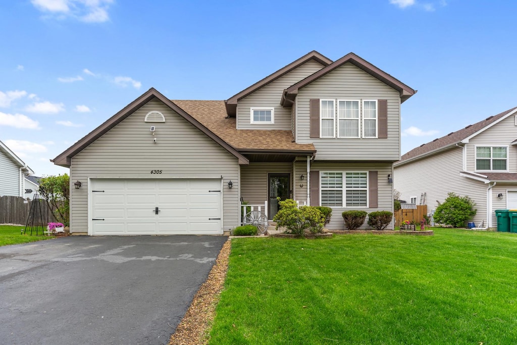 4305 Anthony Ln, Plainfield, IL 60586 - traditional-style home featuring driveway, an attached garage, and roof with shingles