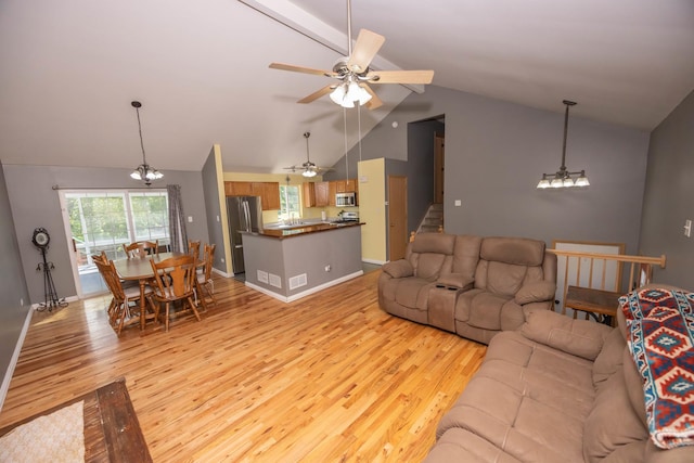 1012 Belden Way, Joliet, IL 60435 - living room featuring light wood-style floors, a chandelier, lofted ceiling, a ceiling fan, and baseboards
