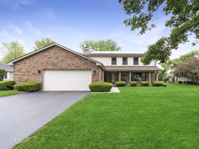 848 Braintree Ln, Bartlett, IL 60103 - view of front of property featuring a garage, brick siding, a chimney, and asphalt driveway