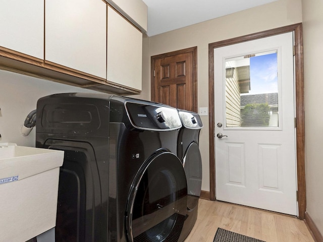 848 Braintree Ln, Bartlett, IL 60103 - laundry area with cabinet space, washer and clothes dryer, light wood-style floors, and baseboards