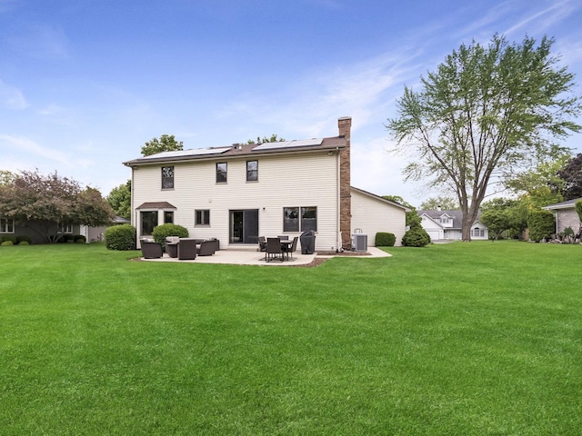 848 Braintree Ln, Bartlett, IL 60103 - back of property featuring solar panels, a patio area, a chimney, and a yard