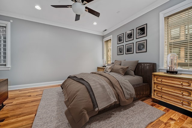 bedroom featuring multiple windows, ornamental molding, recessed lighting, and wood finished floors