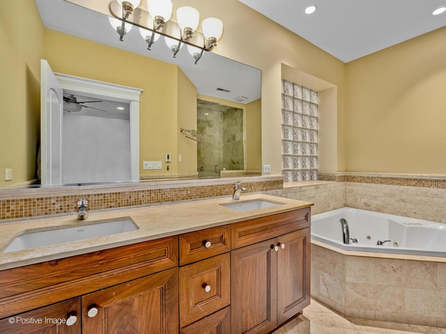 full bath with a sink, double vanity, a whirlpool tub, and a shower stall