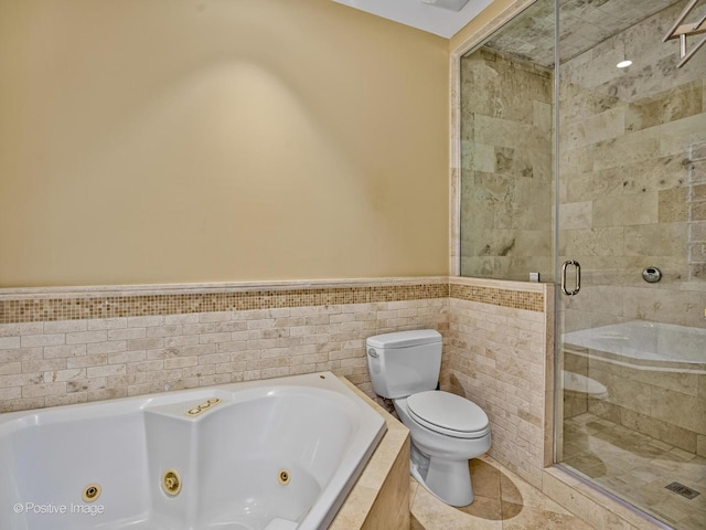 full bath featuring toilet, a wainscoted wall, tile patterned floors, a stall shower, and a whirlpool tub