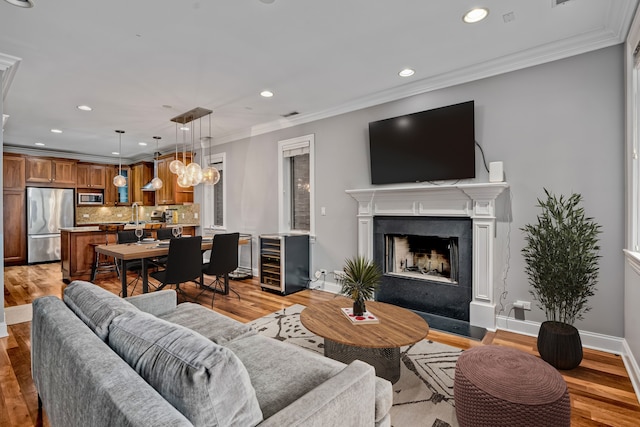 living room featuring recessed lighting, light wood-type flooring, and beverage cooler