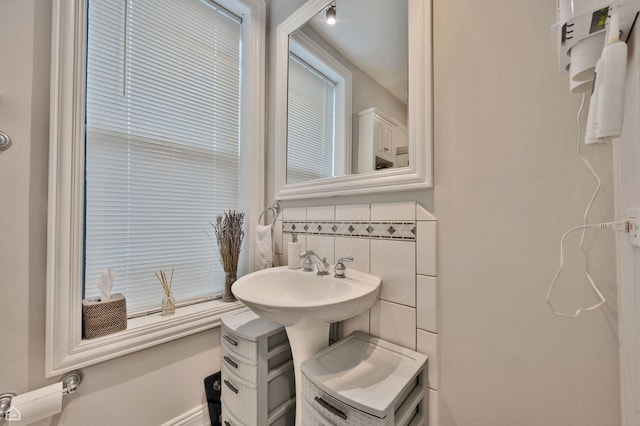 bathroom with tasteful backsplash