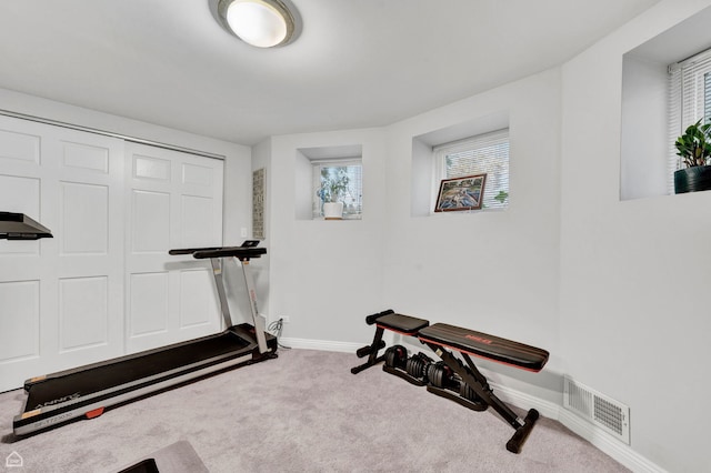 exercise area with carpet and baseboards