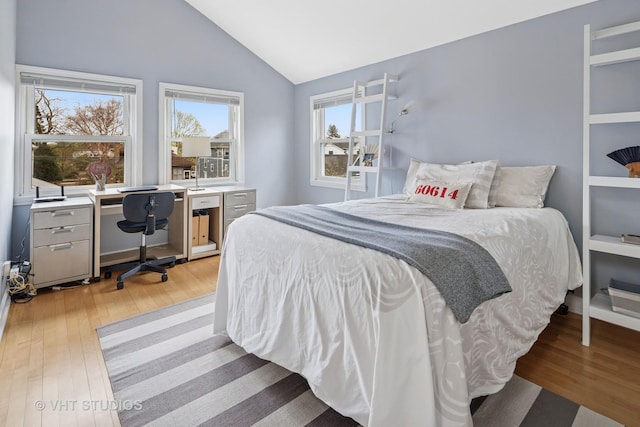 6927 N Oleander Ave, Chicago, IL 60631 - bedroom with light wood-type flooring, vaulted ceiling, and a desk