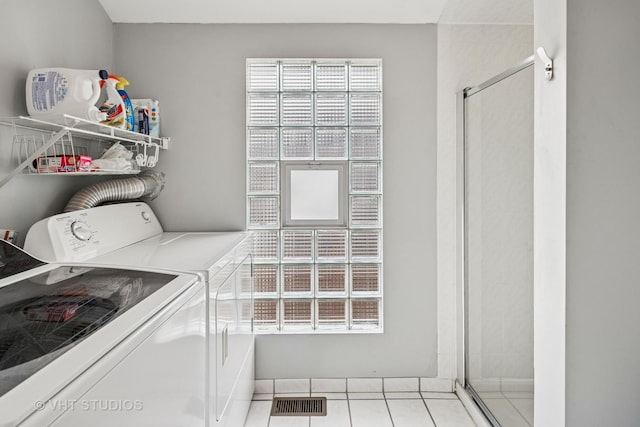 6927 N Oleander Ave, Chicago, IL 60631 - clothes washing area with washing machine and clothes dryer and light tile patterned floors
