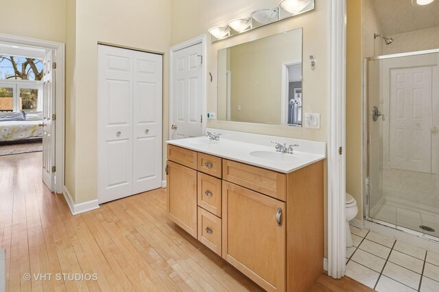 6927 N Oleander Ave, Chicago, IL 60631 - ensuite bathroom featuring a stall shower, hardwood / wood-style floors, toilet, and double vanity