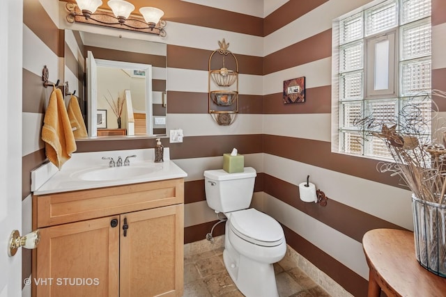 6927 N Oleander Ave, Chicago, IL 60631 - half bath featuring plenty of natural light, toilet, vanity, and stone finish floors