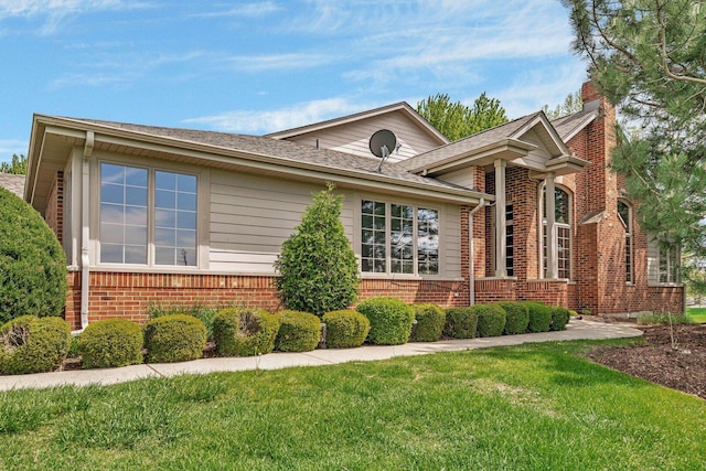 472 Linden Cir, Beecher, IL 60401 - view of front of property with brick siding, a front yard, a chimney, and roof with shingles