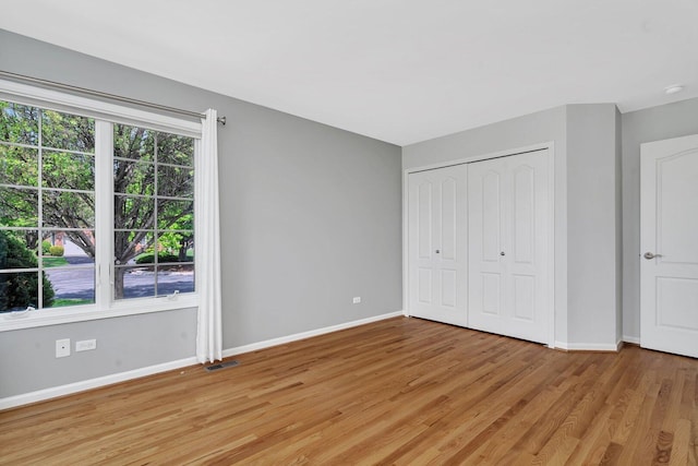 472 Linden Cir, Beecher, IL 60401 - unfurnished bedroom featuring baseboards, light wood-style flooring, and a closet