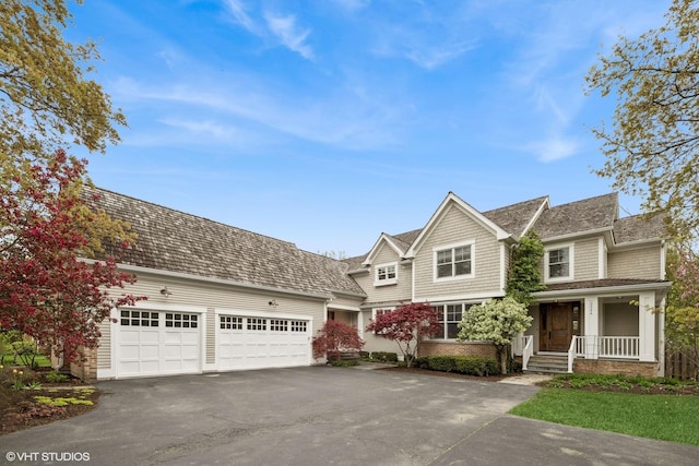 3324 Lakeside Ave, Northbrook, IL 60062 - view of front of property with asphalt driveway, an attached garage, and a porch