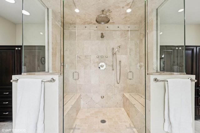bathroom featuring a stall shower and recessed lighting