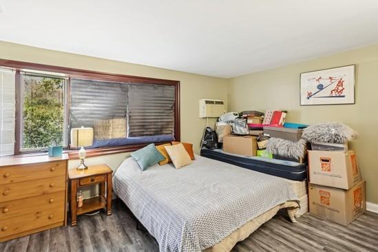2104 S River Rd, Des Plaines, IL 60018 - bedroom with wood finished floors and a wall mounted air conditioner