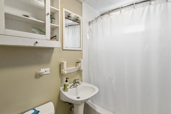 2104 S River Rd, Des Plaines, IL 60018 - full bath with toilet, a sink, and a shower with shower curtain
