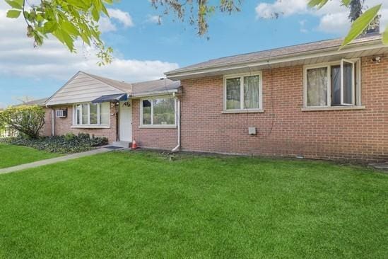 2104 S River Rd, Des Plaines, IL 60018 - view of front of house with a front yard and brick siding