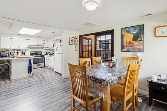 2104 S River Rd, Des Plaines, IL 60018 - dining space featuring wood finished floors and baseboards