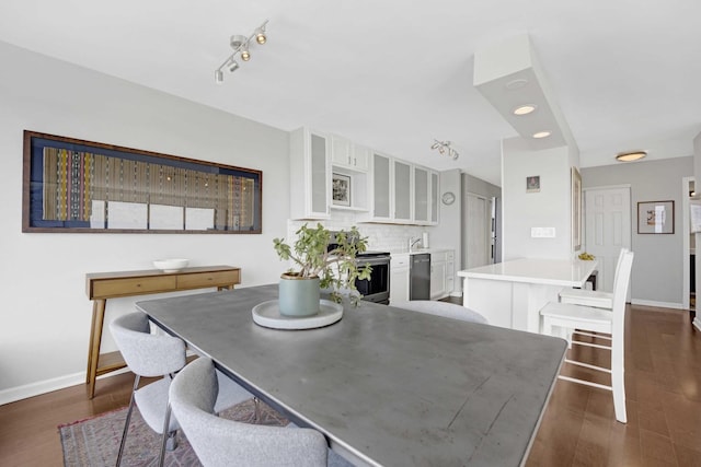 5455 N Sheridan Rd Unit 2915, Chicago, IL 60640 - dining room with dark wood finished floors, baseboards, and rail lighting