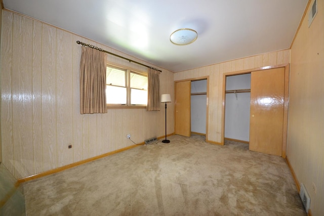 2820 S Shields Ave, Chicago, IL 60616 - unfurnished bedroom featuring two closets, light colored carpet, and baseboards