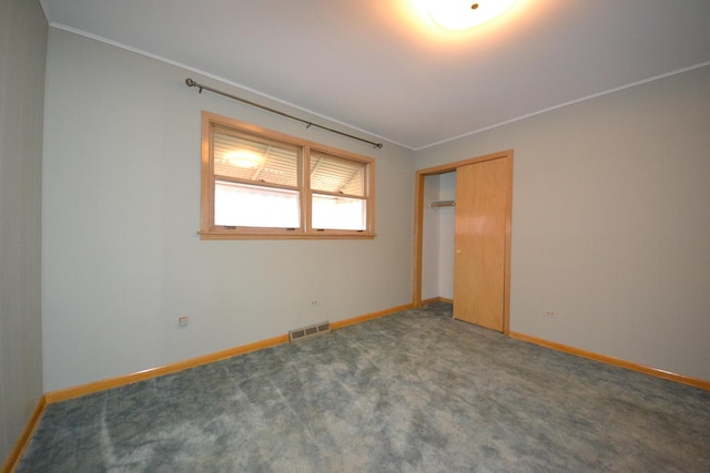 2820 S Shields Ave, Chicago, IL 60616 - unfurnished bedroom with baseboards, ornamental molding, a closet, and carpet flooring
