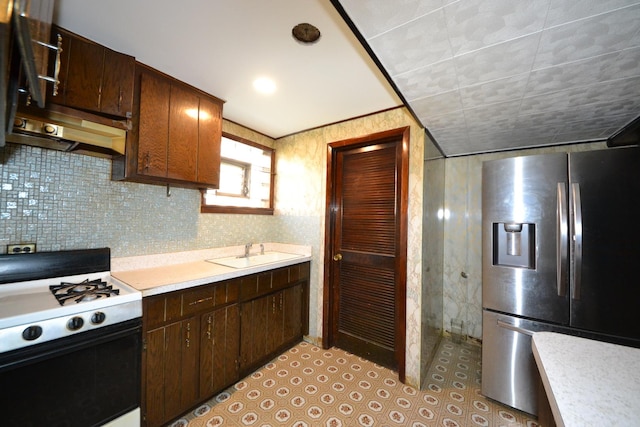 2820 S Shields Ave, Chicago, IL 60616 - kitchen with stainless steel fridge with ice dispenser, range with gas cooktop, a sink, light countertops, and dark brown cabinetry
